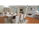 Open-concept living and dining area with a bar and hardwood floors, perfect for entertaining at 950 Mill Creek Ave, Canton, GA 30115