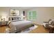 Comfortable bedroom with a stylish headboard, armchair and a large window for natural light at 950 Mill Creek Ave, Canton, GA 30115