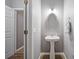 Well-lit powder room with a pedestal sink, mirror, and gray walls at 950 Mill Creek Ave, Canton, GA 30115