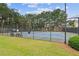 Community tennis courts surrounded by fencing, with benches for players to rest at 950 Mill Creek Ave, Canton, GA 30115