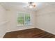 This walk-in closet has wood floors, a window, and built-in shelving at 950 Mill Creek Ave, Canton, GA 30115