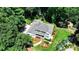 Stunning aerial view of a home surrounded by lush greenery and landscaped gardens at 9585 Fenbrook Ct, Johns Creek, GA 30022