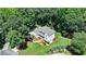 Aerial showing a well-maintained home with a large yard and lush landscaping at 9585 Fenbrook Ct, Johns Creek, GA 30022