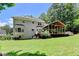 Expansive backyard featuring a screened-in porch with a wooden deck and lush green grass at 9585 Fenbrook Ct, Johns Creek, GA 30022
