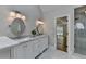 Bright bathroom with marble counters, dual sinks, and a glass enclosed shower at 9585 Fenbrook Ct, Johns Creek, GA 30022