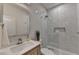 Modern bathroom with a glass shower, rainfall shower head, floating vanity, and marble-like tile at 9585 Fenbrook Ct, Johns Creek, GA 30022