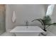 Modern bathroom features a soaking tub with chrome hardware and a plant for decoration at 9585 Fenbrook Ct, Johns Creek, GA 30022
