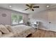 Bedroom features a ceiling fan, light hardwood flooring, and a window with outside views at 9585 Fenbrook Ct, Johns Creek, GA 30022