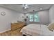 Bedroom features hardwood floors, a ceiling fan, a window, and a dresser at 9585 Fenbrook Ct, Johns Creek, GA 30022