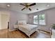Bright bedroom with a ceiling fan, large window, and light-colored walls at 9585 Fenbrook Ct, Johns Creek, GA 30022
