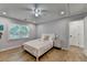 Bright bedroom offers natural light, wood floors, and neutral decor at 9585 Fenbrook Ct, Johns Creek, GA 30022