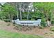 Kingston Crossing community sign surrounded by landscaped flower beds at 9585 Fenbrook Ct, Johns Creek, GA 30022