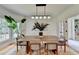 Bright dining room with modern lighting, neutral furniture, large windows, and elegant decor at 9585 Fenbrook Ct, Johns Creek, GA 30022