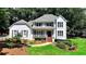 Charming two-story home with a landscaped front yard, a welcoming porch, and a symmetrical design at 9585 Fenbrook Ct, Johns Creek, GA 30022
