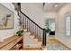 Inviting foyer with staircase, wood floors, decorative rug, and views into the living area at 9585 Fenbrook Ct, Johns Creek, GA 30022