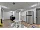 Basement kitchenette area with a table, chairs, cabinets, and a refrigerator at 9585 Fenbrook Ct, Johns Creek, GA 30022