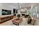 Spacious living room with stone fireplace, a TV, and a decorative bar area at 9585 Fenbrook Ct, Johns Creek, GA 30022