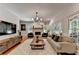 Bright living room with a fireplace, recessed lighting, and multiple windows at 9585 Fenbrook Ct, Johns Creek, GA 30022