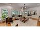 Bright and airy living room features many windows and a view of the kitchen at 9585 Fenbrook Ct, Johns Creek, GA 30022