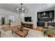 Open-concept living room with wet bar area, hardwood floors, and modern lighting at 9585 Fenbrook Ct, Johns Creek, GA 30022