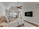 Spacious main bedroom with tray ceiling, wood floors, and a large TV at 9585 Fenbrook Ct, Johns Creek, GA 30022