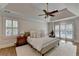 Bright main bedroom with wood floors, tray ceiling, large windows, and plantation shutters at 9585 Fenbrook Ct, Johns Creek, GA 30022