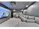 Entertainment room with an oversized television and large sectional couch at 9585 Fenbrook Ct, Johns Creek, GA 30022