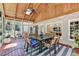 Enclosed patio features wood ceiling with skylight, ceiling fan, tile floor and screened windows at 9585 Fenbrook Ct, Johns Creek, GA 30022