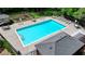 Community pool with lounge chairs and tables, surrounded by a black fence and mature trees at 9585 Fenbrook Ct, Johns Creek, GA 30022