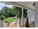 Inviting porch with brick steps and white railings, offering a view of the landscaped yard and trees at 9585 Fenbrook Ct, Johns Creek, GA 30022