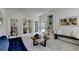 Bright sitting room with French doors, bookshelves, and a comfortable couch at 9585 Fenbrook Ct, Johns Creek, GA 30022