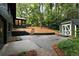 Expansive backyard featuring a patio, storage shed, and lush greenery and mature trees at 2356 Sherbrooke Ne Dr, Atlanta, GA 30345