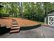 Expansive backyard featuring a storage shed, steps to the yard, and lush greenery and mature trees at 2356 Sherbrooke Ne Dr, Atlanta, GA 30345