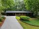 Charming single-story home with green siding, mature trees, and a covered portico at 2356 Sherbrooke Ne Dr, Atlanta, GA 30345
