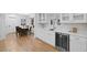 Bright kitchen features white cabinets, a wine fridge, stainless steel appliances and a breakfast nook at 2356 Sherbrooke Ne Dr, Atlanta, GA 30345