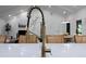 Close up of a kitchen island faucet with a view of the living room and dining room at 2356 Sherbrooke Ne Dr, Atlanta, GA 30345