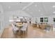 Open-plan living and dining area with cathedral ceilings, hardwood floors, and modern decor at 2356 Sherbrooke Ne Dr, Atlanta, GA 30345