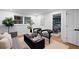 Inviting living room with modern furniture, patterned chairs, and views into the library and bathroom at 2356 Sherbrooke Ne Dr, Atlanta, GA 30345
