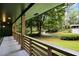 A covered front porch with wood railing overlooks a meticulously landscaped front yard at 2356 Sherbrooke Ne Dr, Atlanta, GA 30345