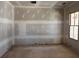 Unfinished bedroom with a large window with exterior brick view at 2759 S Waterworks Rd, Buford, GA 30518