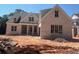 A charming brick two-story home with large windows and unfinished landscaping at 2759 S Waterworks Rd, Buford, GA 30518