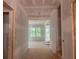 The home's unfinished hallway leads into a room with abundant natural light at 2759 S Waterworks Rd, Buford, GA 30518