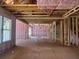 Exposed studs and pink insulation fill the unfinished interior, offering a blank canvas for your dream home design at 2759 S Waterworks Rd, Buford, GA 30518