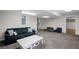 Spacious basement living area with plush carpet and modern decor at 640 Windwalk Dr, Roswell, GA 30076