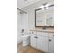 Bright bathroom featuring granite countertops, white cabinetry, and tile flooring at 640 Windwalk Dr, Roswell, GA 30076