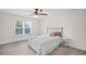 Bright bedroom with neutral colors features a window with shutters, soft carpet, and comfortable bed with stylish pillows at 640 Windwalk Dr, Roswell, GA 30076