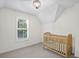Cozy bedroom showcases neutral colors, shutters on the window, and a baby bed with a wood frame at 640 Windwalk Dr, Roswell, GA 30076