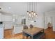 Bright open concept kitchen featuring white cabinets, stainless steel appliances, granite counters, and an island cooktop at 640 Windwalk Dr, Roswell, GA 30076