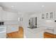 Bright kitchen features white cabinets, stainless steel appliances, granite counters, and an island cooktop at 640 Windwalk Dr, Roswell, GA 30076
