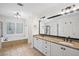 Elegant main bathroom with dual sinks, granite countertops, large mirrors, a soaking tub, and separate shower at 640 Windwalk Dr, Roswell, GA 30076